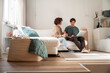 © ADDICTIVE STOCK - Couple planning finances on laptop in bright living room