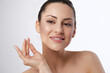 © verona_studio - Pretty woman beauty portrait smiling with natural clean skin, female model showing smooth healthy complexion, skincare facial cosmetology and beauty care concept in studio