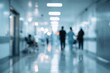 © RushBoy - A blurred view down a brightly lit hospital corridor shows figures walking away from the viewer.