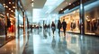 © Ria - A blurred image depicts a busy shopping mall corridor with indistinct figures of people walking.
