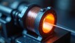 © Pete - Industrial device with copper coil emits orange glow. Precise instrument tests material property. Science lab equipment works on precise sensor technology.