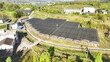 © zhu difeng - Rural agricultural greenhouses covered with shade nets in neat rows on hilly farmland