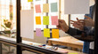© Christine - Hands arranging colorful sticky notes on a glass wall during a creative business brainstorming meeting in an office.