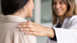 © fizkes - Connection and trust between doctor and patient. Young female therapist put her hand on woman patient shoulder, offers comfort, provide psychological support, reassuring during consultation, close up