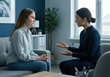 © Breezze - Two women having a serious conversation in a modern office for mental health awareness, professional counseling services and psychological support campaign