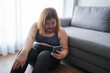© Charlie's - Obese asian woman dieting Weight loss in sportswear using smart phone after workout for weight control at home wellness health.