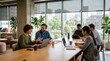 © AKANG - Diverse Group of Professionals Collaborating and Having a Meeting in Modern Sunlit Office Space