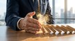 © Umi12 - Businessman in a suit dramatically stopping falling dominoes mid-collapse, preventing disaster and representing crisis management, strategic intervention, and risk mitigation.
