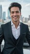 © Alexander Chaykin - A young, smiling businessman in a suit poses confidently against the backdrop of a city skyline.