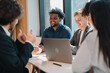 © chokniti - Business professionals discussing ideas in urban setting corporate communication teamwork consultation partnership strategy planning modern workplace collaboration