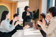 © chokniti - Business meeting teamwork diverse group office professional collaboration success happy discussion presentation. diverse team of professionals modern office applauding colleague during successful