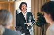© chokniti - Businessman presentation office meeting teamwork collaboration professional corporate discussion leadership Confident businessman leads presentation modern office meeting, encouraging teamwork