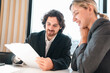 © chokniti - Business team meeting discussion collaboration presenting data analysis corporate teamwork diverse professionals planning strategy office communication partnership