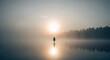© Thanawat_Suesoypan - Solitary Figure on Misty Lake, Nature Photography, Serene Environment, Tranquil Viewpoint