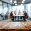© Radianshots - A group of people meets in a modern office setting to talk and collaborate on projects at a wooden table during the day