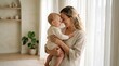 © Arsal Stock - Loving young mother holding her baby in a bright living room, happy mom and infant child bonding at home, tender motherhood moment in a minimalist interior