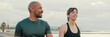 © Andrii Nekrasov - Close-up of an active young sporty couple have dialog, two athletes enjoy conversation and walking. Panoramic