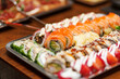 © 9parusnikov - Large assortment of fresh sushi rolls on a metal tray