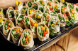 © 9parusnikov - Healthy vegetable wrap slices with colorful peppers and greens on a platter
