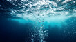 © Defined Digital - Underwater View of Rising Air Bubbles Ascending Toward Bright Ocean Surface with Blue Light