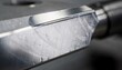 © DigitalSpace - Closeup medium shot of a cutting tool undergoing mirror polish emphasizing the smooth reflective surface that enhances precision and reduces friction in highspeed cutting