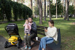 © Anna - family of three: a mother and father with a cute baby on a walk in the park. parents relax outdoors with their little child