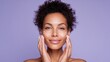 © StasySin - Soft cream glides gently across her skin. Her calm expression radiates serenity. Hands cradle her face with care. Purple backdrop enhances soothing elegance. Perfect for skincare, wellness