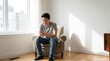 © Rans'z - Young Man Scrolling Smartphone at Home with Relaxed Lifestyle