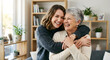 © ZenqoraStock - Happy daughter hugging her elderly mother celebrating Mother's Day indoors in a cozy home