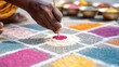 © Anna - Hands applying colored powder with tool to geometric kolam grid for diwali festival background,Bonalu