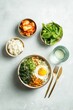 © spyrakot - Top down wellness meal planner lay kimchi greens rice bowl water glass