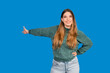 © EDUARDOIVAN - Smiling woman presenting concept with outstretched hand