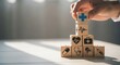 © mlangsen - Hand stacking wooden blocks with medical symbols forming a healthcare tower