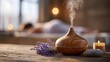 © rabbit75_fot - Therapy stress release treatment, health lifestyle. A wooden diffuser emitting a pleasant aroma, accompanied by a lavender flower and a lit candle, set against a blurred background.