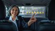 © JuliaDorian - Businesswoman in car smiling and interacting with digital interface displaying five-star rating, showcasing customer satisfaction and engagement in modern transportation