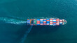 © Yellow Boat - large cargo container ship fully loaded with colorful containers sailing through the deep blue ocean. Global maritime trade, freight transport and logistics business.