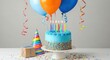 © twilight mist - Blue frosted birthday cake sits on a table surrounded by balloons, streamers, a party hat, and a wrapped gift.