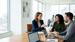 © Xenia - Female corporate manager coaching diverse team members in a modern office. Business colleagues discussing project strategy at a conference table. Leadership and mentoring concept