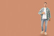 © Atlas - Confident young man in casual attire smiling and giving thumbs up