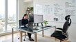 © Sithija - Asian woman working on computer at modern office desk with whiteboard