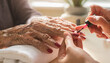© catocala - Creative macro shot shows a year old woman's hands getting a red manicure in a bright setting, highlighting age and care