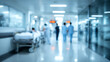 © CStock - Blurred hospital corridor with medical staff and patients, illustrating healthcare environment and patient care.