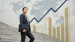 © BigScore - Asian woman gray suit portfolio descending outdoor stairs 3D gold outline bar chart zigzag arrow world map determined global finance career concept