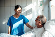 © Westend61 - Nurse providing care and support to a patient in a hospital setting