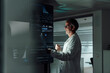 © Westend61 - Doctor analyzing medical data on digital screens working overtime