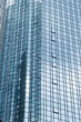 © yaqui_villegas - Vertical glass tower skyscraper with modern architecture facade windows grid and reflections on highrise building creating corporate urban background
