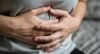 © Laurent - Close Up Of Woman Pressing Her Abdomen Showing Signs Of Severe Stomach Pain And Bloating