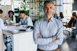 © Kostiantyn - Selfassured Executive. Selfassured Chief Executive Placed In Open Plan Office With Natural Light And Greenery