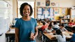 © Eve - Cheerful black woman teacher standing in classroom holding notebook with students working at desks, elementary education and professional concept