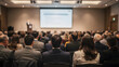 © Fikri Haikal - Rear view of people in audience at the conference hall, Speaker giving a talk in conference hall at business event.